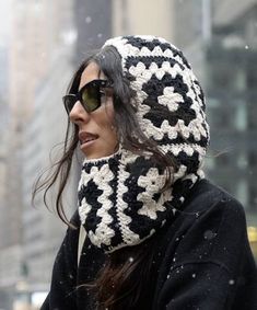 a woman wearing a black and white crocheted hat