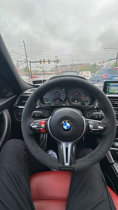 the interior of a bmw car with red leather seats and steering wheel covers on it