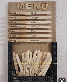 wooden utensils are arranged in a box with the words menu written on them