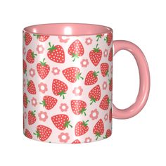 a pink coffee mug with strawberries on it