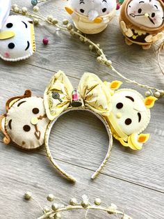 several small animal headbands sitting on top of a wooden table