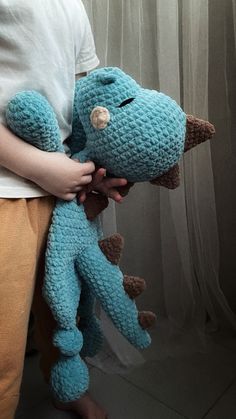 a person holding a stuffed animal in their hands