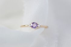 *This listing is for one Freya, purple sapphire + natural white diamonds only* She's finally here! Meet our newest addition to the family - Freya! Made of a natural alluring purple sapphire as a focal stone and accented with 2 sparkling with diamonds flanked on the side in solid 14K yellow gold on our signature fine and delicate band. Specifications: - Solid 14K Yellow Gold (no plating) - 1.2mm (width of band) - 0.25 CT natural purple sapphire, heated, VS clarity - 0.06 CWT natural white diamond Wedding Rings Purple Diamond, Purple Sapphire Ring In 14k Gold For Wedding, Purple Sapphire Birthstone Ring With Diamonds, Purple Sapphire Ring With Diamond Birthstone, Purple Diamond Ring With Birthstone, Purple Sapphire Ring With Diamond, Purple Sapphire Diamond Ring For Anniversary, Purple Sapphire Ring, Sparkly Ring