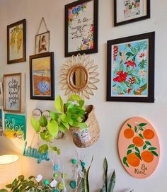 there are many framed pictures on the wall with plants in pots and potted plants