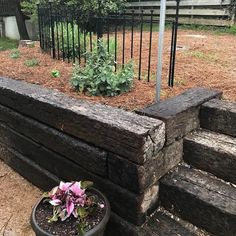 a planter filled with flowers sitting on top of wooden steps