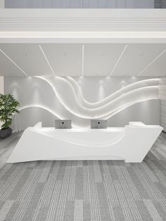 an empty reception area with white furniture and a plant in the corner on the floor