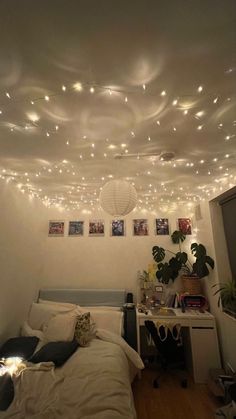 a bedroom with white lights hanging from the ceiling