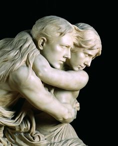 a statue of two people hugging each other