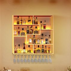 a bar with liquor bottles and glasses lined up on the wall next to each other