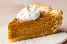 a slice of pumpkin pie with whipped cream on top