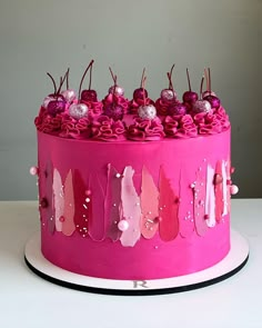 a pink cake decorated with flowers and candy