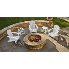 an outdoor fire pit with chairs around it