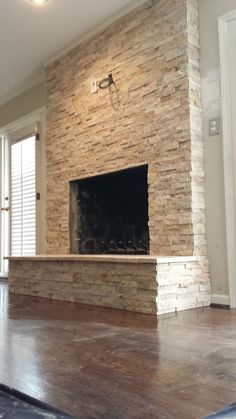 a large stone fireplace in the middle of a room