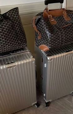 two pieces of luggage sitting next to each other