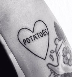 a tattoo with the word potatoes written on it and a heart in the middle that says potatoes