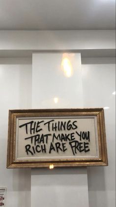 a framed sign that says the things that make you rich are free hanging on a wall