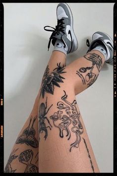 a woman's legs with tattoos on them