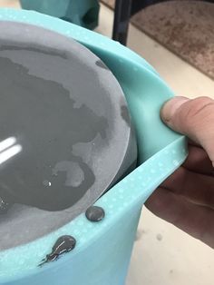 a person is holding a bowl with something in it and touching the bottom of it