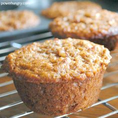 two muffins cooling on a wire rack in the oven, with one muffin partially eaten