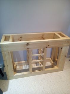 an unfinished kitchen cabinet with the doors open and shelves built into it's sides