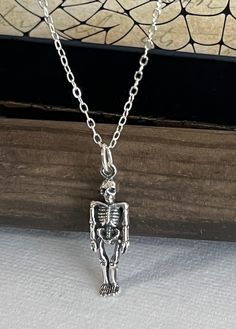 Sterling Silver Skeleton - Small Skelton Necklace, Skull and Bones, Silver Skeleton Necklace, Skeleton Jewelry, Halloween Jewelry, Gothic Jewelry, Holiday Gifts. ✦pendant measures: 26x7mm ✦sterling silver box or cable chain choices below **PLEASE NOTE: THIS LISTING IS ONLY FOR ONE NECKLACE ONLY. ** Add a birthstone link below. https://www.etsy.com/shop/DaintyShack?ref=simple-shop-header-name&listing_id=770404331§ion_id=24538410 🎁 Comes ready to gift in a gift box or bag. ♥BUY WITH CONFIDENCE♥ P Punk Skull Jewelry For Halloween, Punk Style Skull Jewelry For Halloween, Punk Style Skull Print Necklace For Gifts, Metal Skull Print Jewelry For Halloween, Halloween Silver Jewelry With Skull Print, Silver Skull Print Jewelry For Halloween, Gothic Skull Print Necklace For Gifts, Silver Skull Jewelry For Halloween, Skull Shaped Silver Jewelry For Halloween