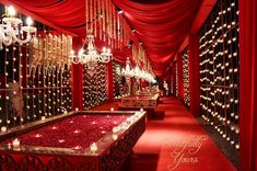 a red carpeted hallway with chandeliers and lights