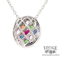 This necklace features an oval shaped colored gemstone and diamond mosaic pendant crafted from 14 karat white gold. It features 21 assorted semi-precious gemstones totaling 2.45 carats, as well as .55 total carats of G color, SI clarity, round brilliant diamonds. The included 18" rope link chain is also crafted from 14 karat white gold. 14 karat white gold oval shaped colored gemstone and diamond mosaic pendant 21 assorted semi precious colored gemstones totaling 2.45 carats .55 total carats of Luxury Multi-stone Round Pendant Necklaces, Luxury Multi-stone Round Pendant Necklace, Luxury Multicolor Oval Pendant Jewelry, Colored Gemstones, Diamond Mosaic, Brilliant Diamond, Precious Gemstones, Gemstone Colors, Semi Precious Gemstones