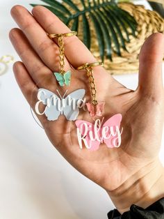 someone is holding three key chains in their hand, with the words summer riley printed on them