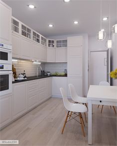 the kitchen is clean and ready to be used for dinner or lunchtime, with all white furniture