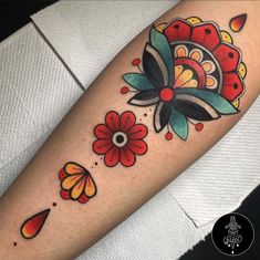 a colorful flower tattoo on the arm