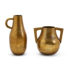 two gold colored vases sitting side by side