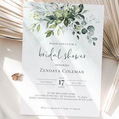 an elegant bridal shower party with greenery and leaves on the front, in white paper