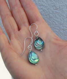 These are Paua Abalone teardrop earrings,  with handmade 925 Sterling Silver earwires.  Paua is the most beautiful mother of pearl of the world. Abalone shines in many shades of green and blue, even purple and pink...and so, each pair is is a little different, each pattern unique, as Abalone mother of pearl is a product of nature! Length 4 cm=157". So you will receive a true one of a kind product! A lovely gift for women and girls! The Sterling earwires are handmade and the ends polished round b Abalone Jewelry, Abalone Earrings, Jewelry Sterling Silver, Green And Blue, Teardrop Earrings, Gift For Women, Shades Of Green, Earrings Handmade, Lovely Gift