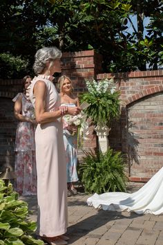 an older woman standing in front of a bride