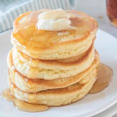 a stack of pancakes covered in butter and syrup