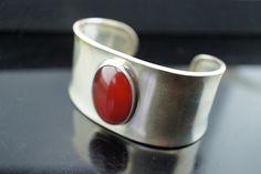 Mexico 925 Vintage Sterling silver Cuff Bracelet Wide Carnelian Stone CII Modern Design Jewelry 1 by VintageEstate86 on Etsy Modern Red Cabochon Jewelry, Handmade Red Sterling Silver Cuff Bracelet, Modern Carnelian Jewelry For Formal Occasions, Red Sterling Silver Bangle Cuff Bracelet, Classic Silver Carnelian Jewelry, Elegant Red Sterling Silver Cuff Bracelet, Modern Silver Bangle With Gemstone, Modern Silver Gemstone Bangle, Modern Hallmarked Bangle As A Gift