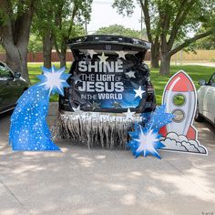 a car parked on the side of a road with some decorations in front of it