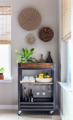 a bar cart with bottles and glasses on it