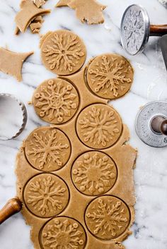 the cookie dough is ready to be cut and decorated with snowflakes on it