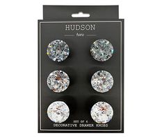 three pairs of diamond studs in packaging