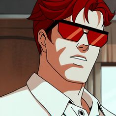 a man with red hair wearing sunglasses and a white shirt