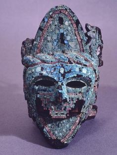 a blue mask is sitting on a purple surface