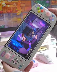 a person holding a nintendo wii game controller in their hand with the screen turned on