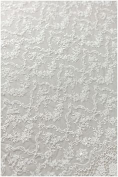 white lace fabric with small flowers on it