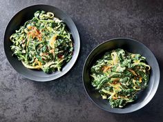 two bowls filled with food sitting on top of a table