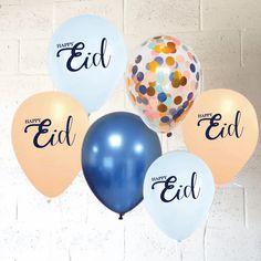 a bunch of balloons that say happy eid and have confetti on them