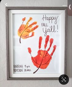 a handprint with the words happy fall y'all written on it is hanging in a frame