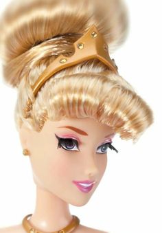 a close up of a barbie doll with blonde hair and a crown on her head