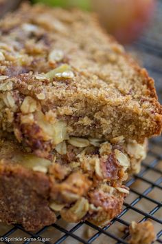 two pieces of bread sitting on top of a cooling rack next to an apple slice