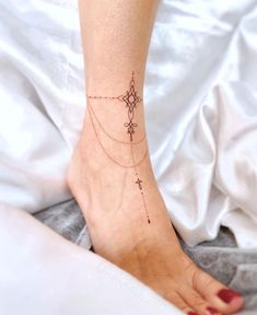 a woman's foot with a small tattoo on the side of her left leg